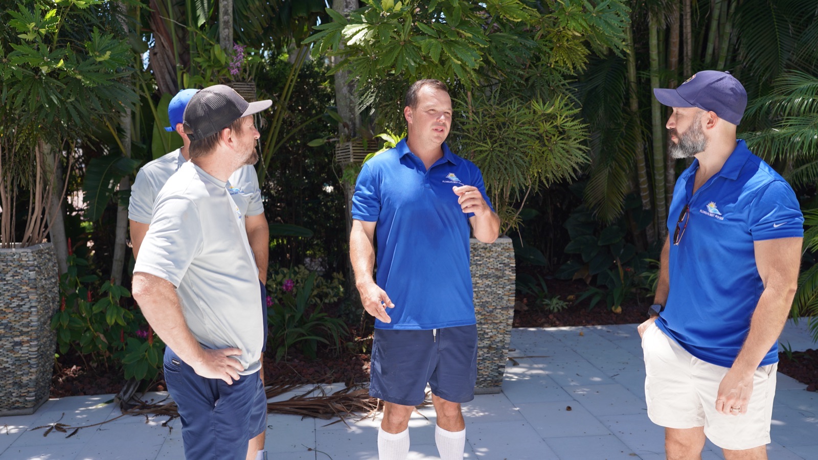 Florida's Best Pools team discussing pool service strategy